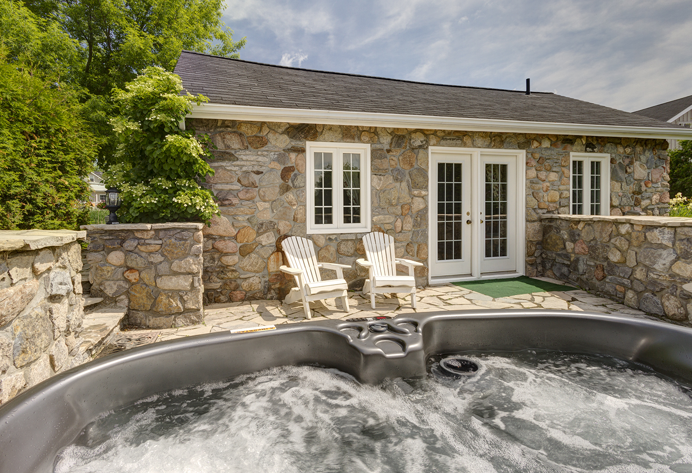 Cottage patio with hot tub feature